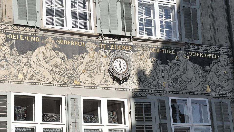 Mural depicting colonial trade goods on a house on Spalenberg